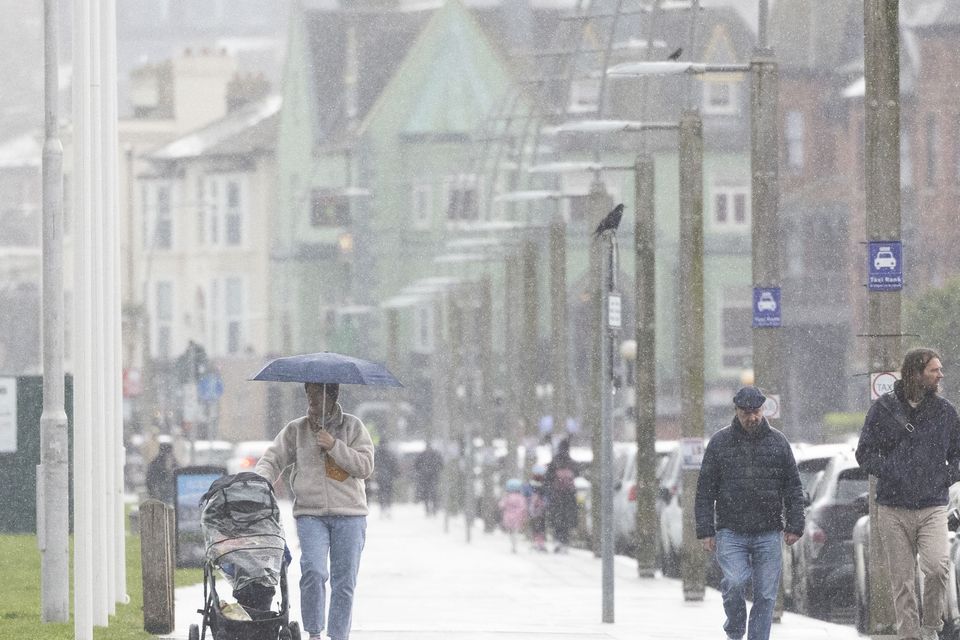 Pedestrians brave heavy rain in Bray, Co Wicklow. Photo: Collins